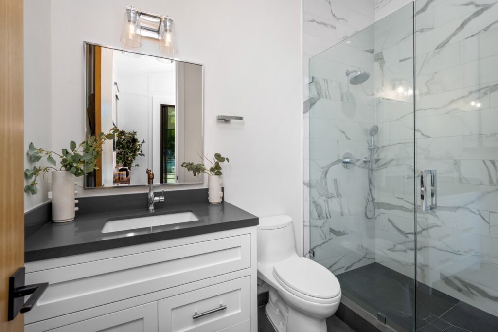 a white toilet sitting next to a walk in shower ne 2024 04 22 17 14 29 utc Large